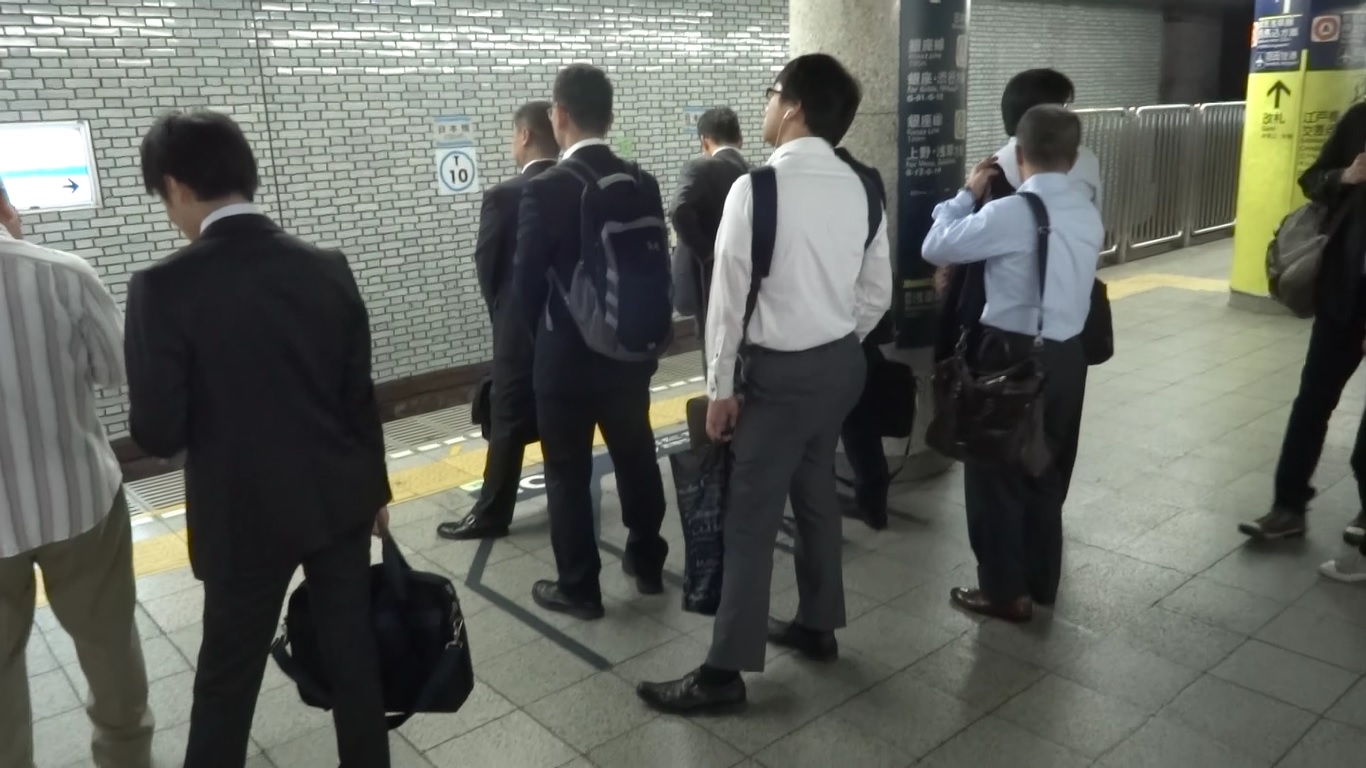 People waiting in line for the next metro train.